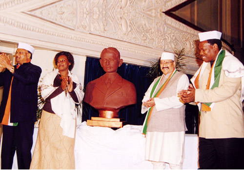 Satpal Ji Maharaj donating bust of Mahatma Gandhi (when he was a barrister) to the Deputy Mayor of Pietermaritzburg, for installation at Pietermaritzburg Railway Station, where Mahatma Gandhi was thrown out of a compartment reserved for whites.